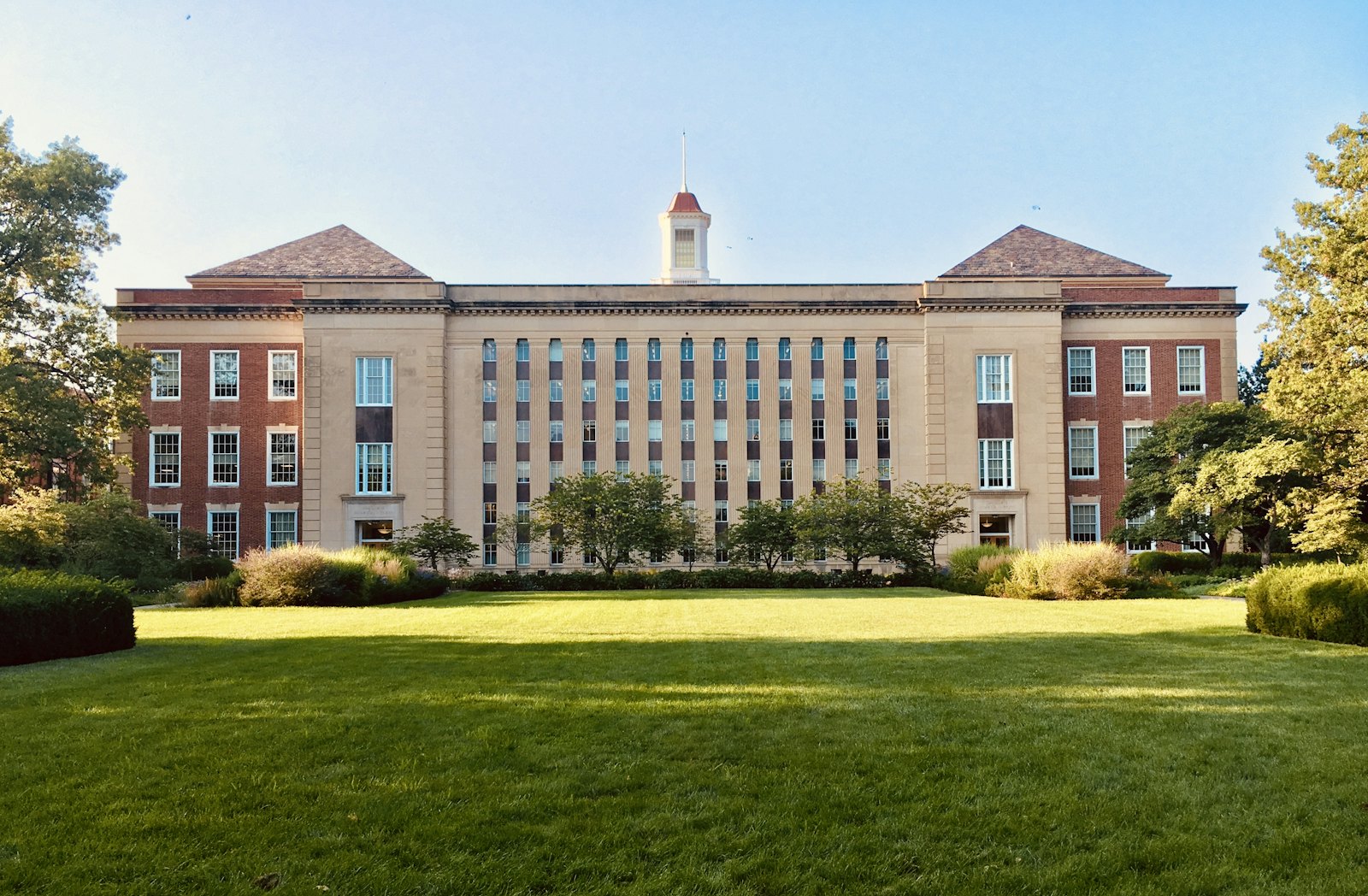 A quiet academic building facing an open lawn.