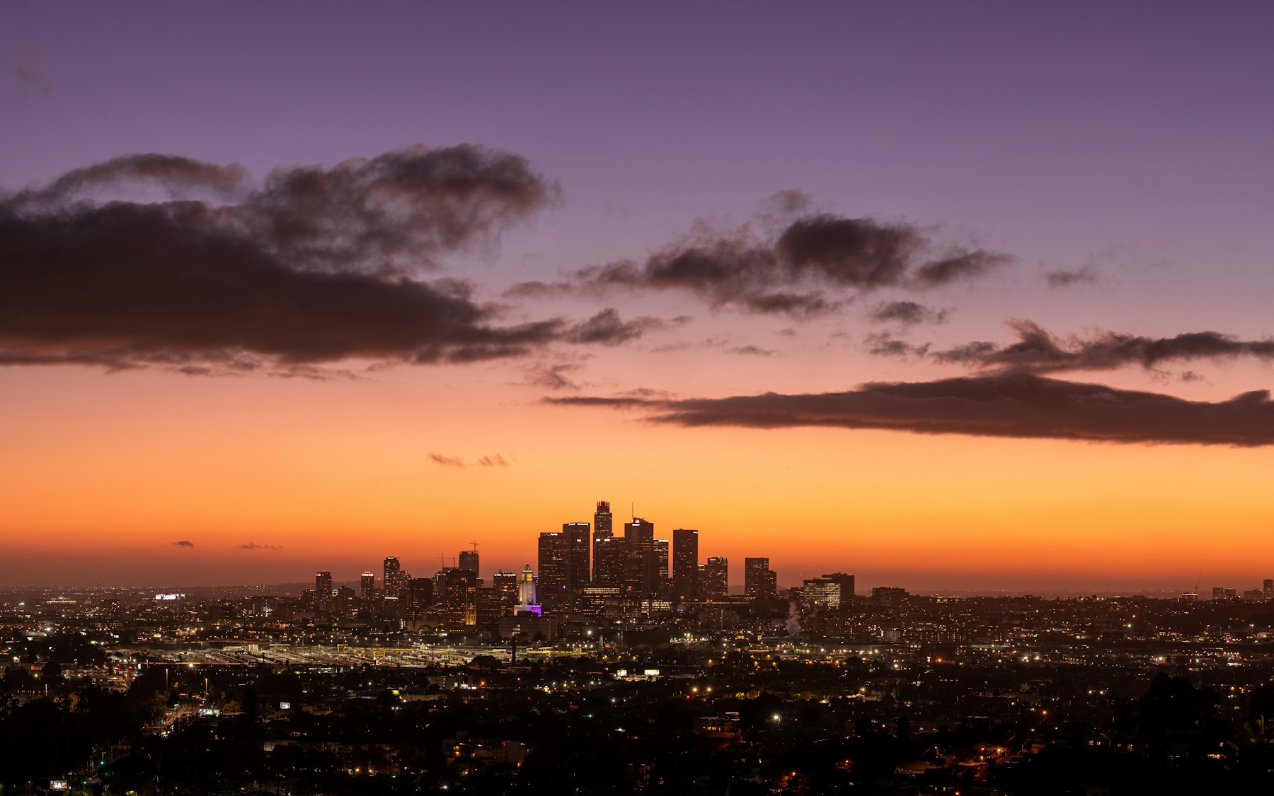 Downtown Los Angeles at dusk, seen from a distance.